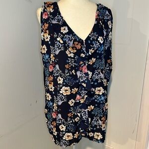 Blue floral tank top, ruffled neck. Mostly solid navy back. Size 2x.